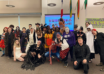 Students pose together wearing Halloween costumes in the Student Union on the SUNY JCC Jamestown campus.