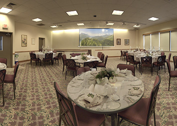 The Weeks Conference Room with AI generated place settings and a projector screen on the back wall.