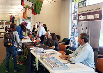 Students visit tables set up by area organizations in the Student Union at SUNY JCC.