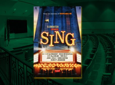 Poster for the animated movie Sing displayed in front of a dimly lit auditorium with tiered seating. The poster features bright marquee-style lettering and lists voice actors including Matthew McConaughey, Reese Witherspoon, and Scarlett Johansson.