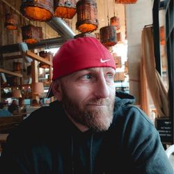 Ethan Fisher wearing a backwards red baseball cap
