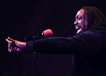 Ed Mabrey Singing into a microphone.