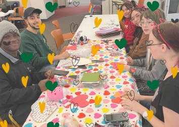 Students at a table creating Valentines.