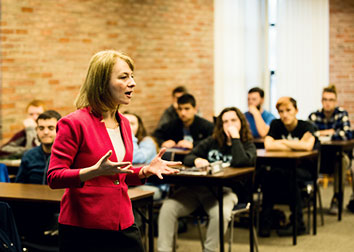 A person addresses a room of students at SUNY JCC. 