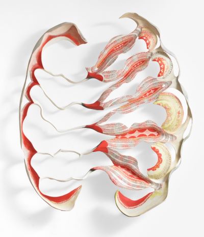 Abstract sculpture with flowing, undulating layers in shades of red, beige, and white. The design conveys a sense of movement and fluidity.