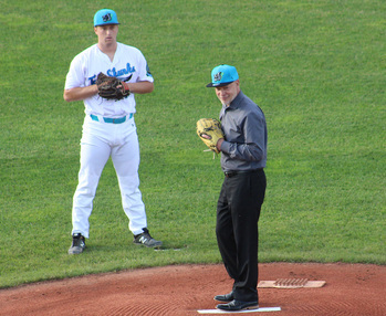 An image of Daniel DeMarte, standing on pitcher's mound at Diethrick Park with a baseball player standing behind him.