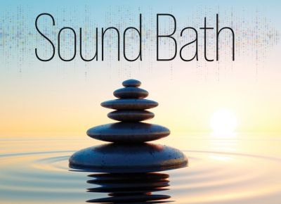 A graphic that shows stones stacked above water outdoors with the words Sound Bath.