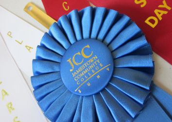 A blue ribbon with the SUNY JCC logo.
