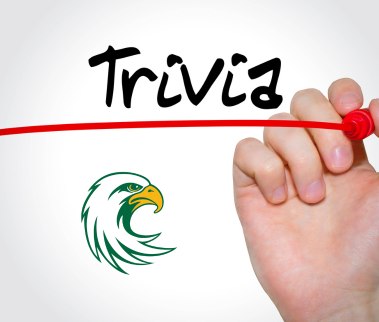 A hand draws a red line under the word "Trivia" in black, with a stylized green and yellow JCC Jayhawk logo below, set against a white background.