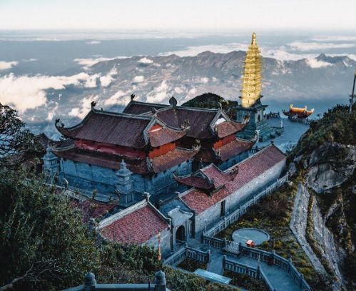 A picturesque Vietnam mountain scene featuring a pagoda elegantly perched at the summit, offering breathtaking views.