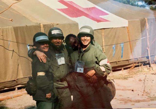 Cheri Foti, right, stands with three other members of the U.S. Air Force with the Red Cross logo draped on a tent in the background