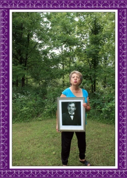 Woman holding a portrait of a deceased ancestor.