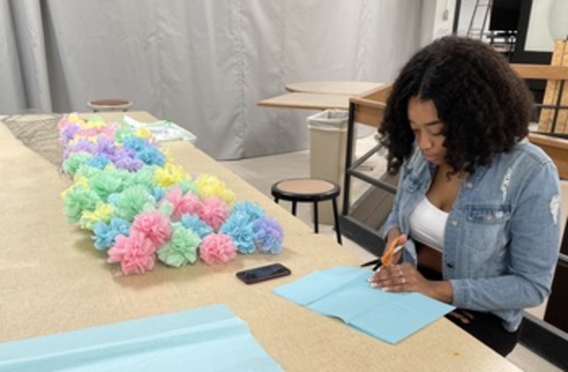 Pictured is Hannah Hicks, SUNY JCC student athlete and artist, working on her art project.