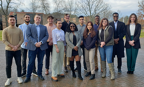 Members of student senate stand on outside on the SUNY JCC Campus.