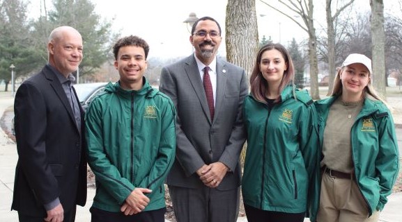 JCC president and students pose with SUNY chancellor on campus.