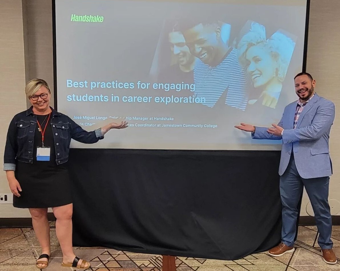 Presenters at a conference show off their presentation screen.
