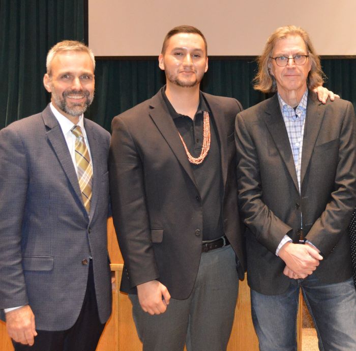 Caleb Abrams posing with a film producer and director.