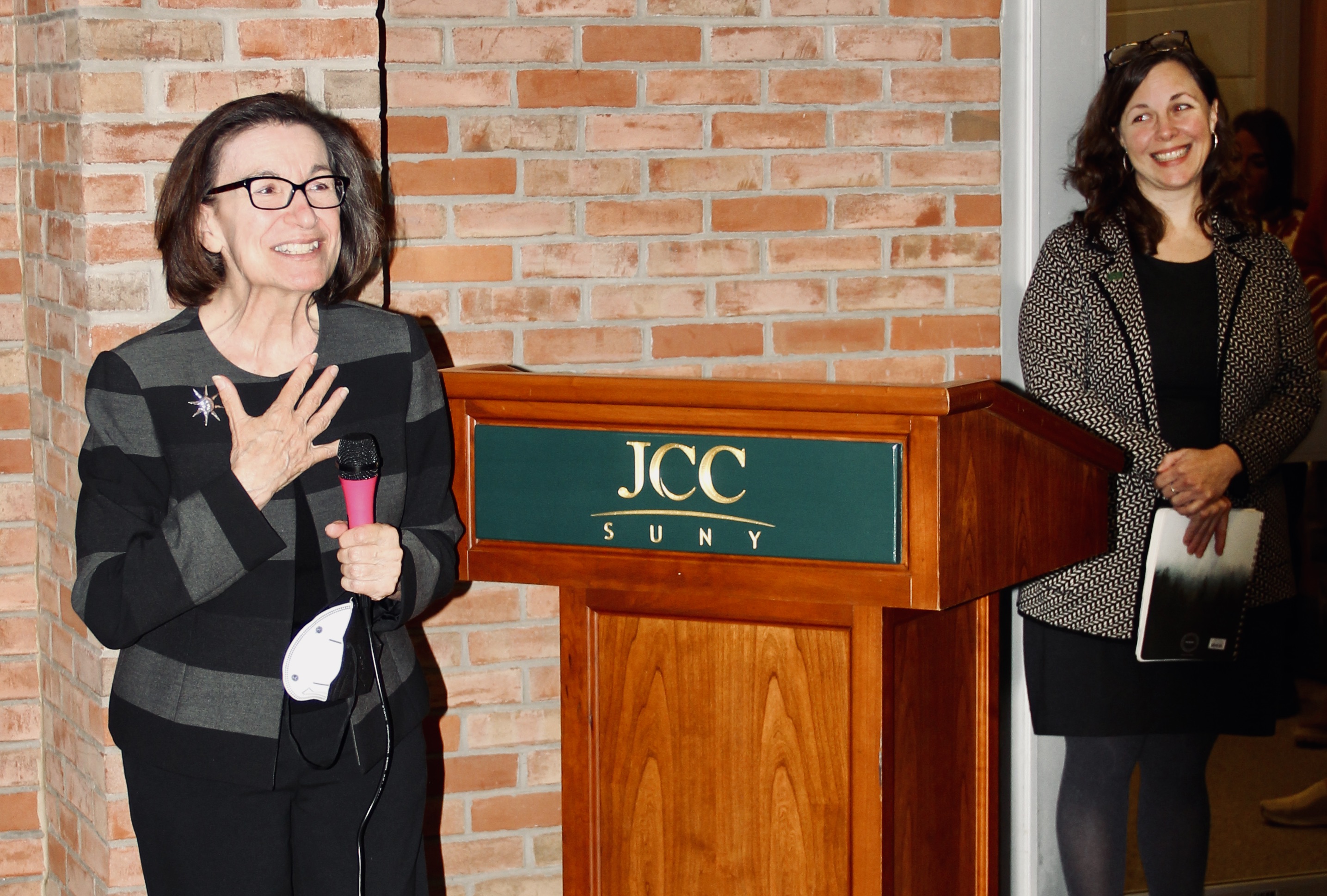 Marilyn Zagora talks while others look on during a bench dedication.