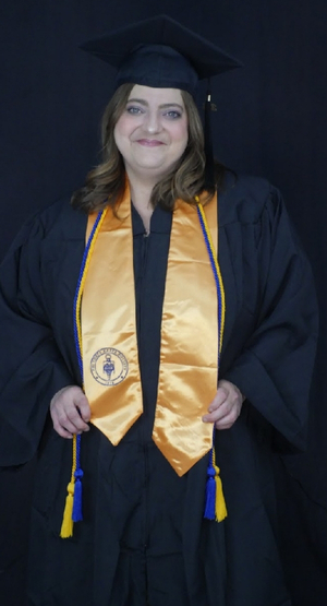 Woman in graduation cap and gown.
