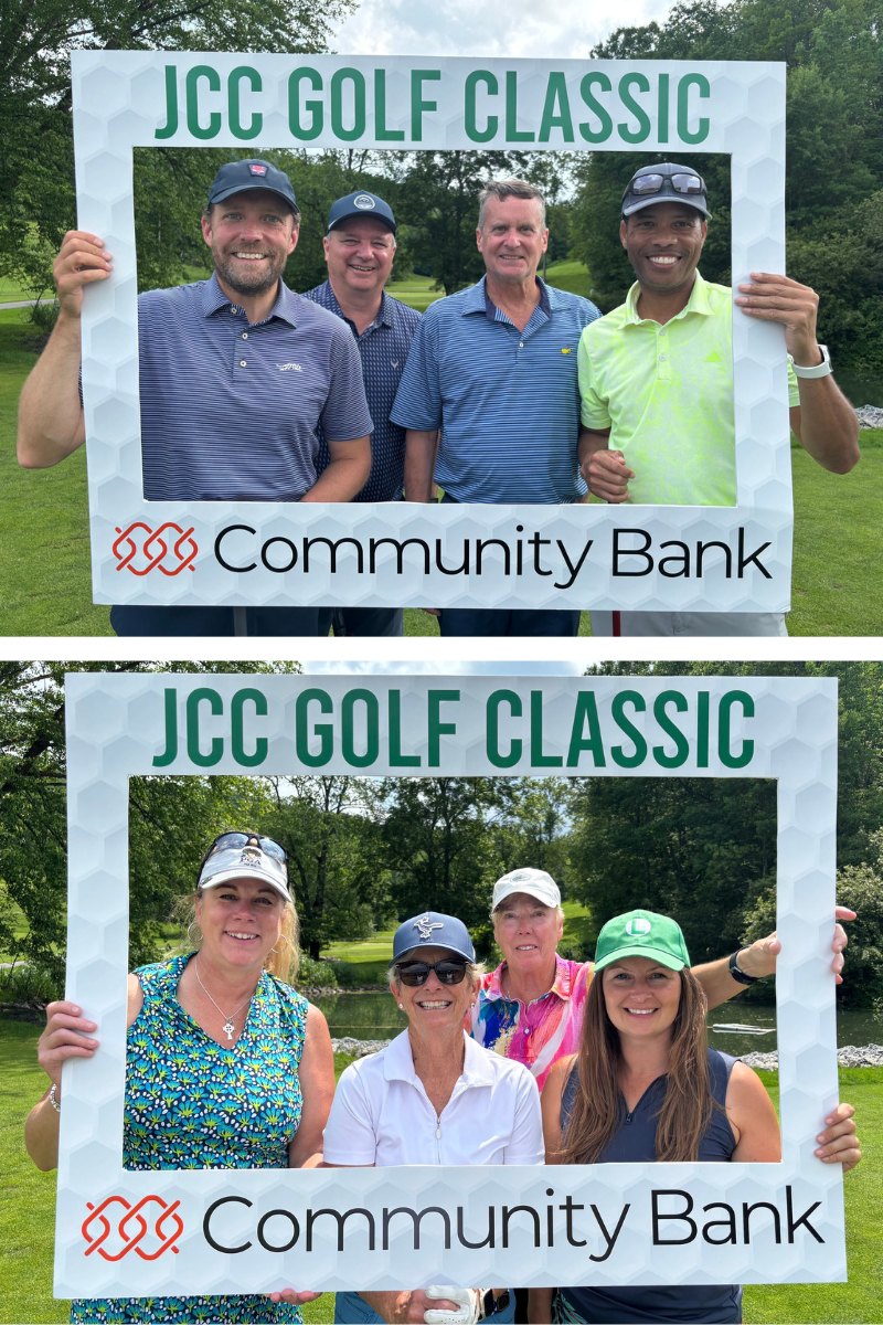 Two group photos taken outdoors at the JCC Golf Classic show smiling participants posing with a large branded photo frame that reads “JCC Golf Classic” and “Community Bank.” Top image: Four men stand together on the green, all smiling and dressed in golf attire, with trees and blue sky in the background. Bottom image: Four women pose with the same frame, also smiling and dressed in colorful golf outfits, with a pond and greenery behind them.