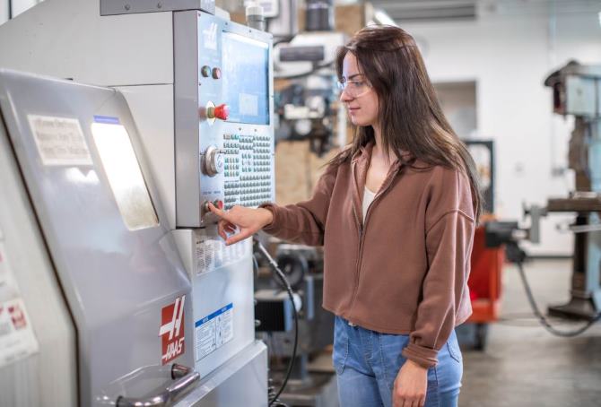 A JCC student works on a CNC machine.