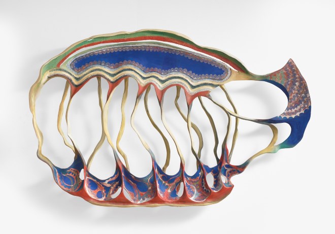 Colorful abstract sculpture resembling a fish. Undulating layers of blue, red, and green form a fluid, wave-like structure, evoking movement and creativity.