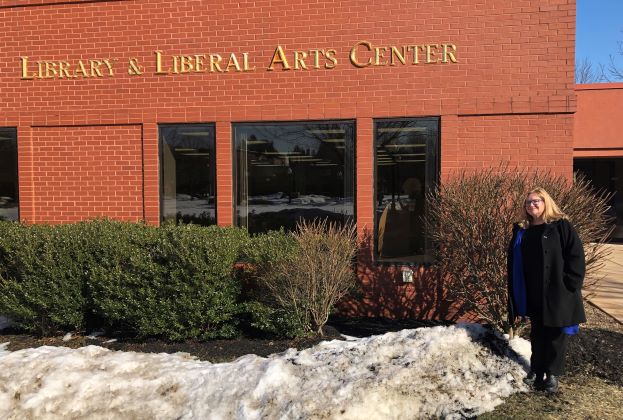 Muralist Meg Saligman standing outside SUNY JCC's Library & Liberal Arts Center