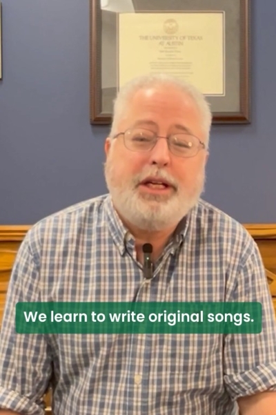 Screenshot of a video of a person talking with the words We learn to write original songs.