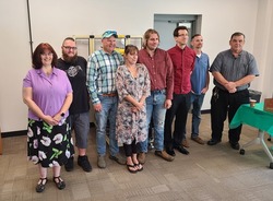 Graduates of SUNY JCC's Maintenance Technician and Machining/CNC Operator programs stand together for a picture after their graduation ceremony