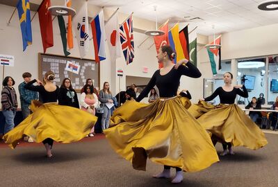 Dancers in full skirts twirl under the international flags of the Student Union at SUNY Jamestown Community College.