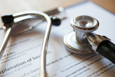 A stethoscope set on top of medical documentation.
