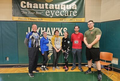 5K participants pose in a gym after finishing the race.