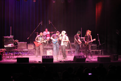 A student rock band jams on stage.