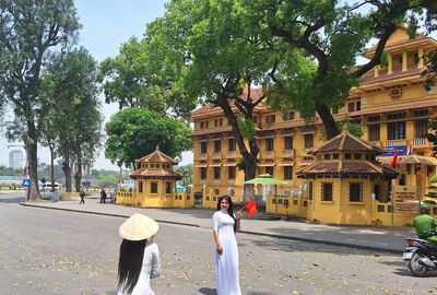 Two Vietnamese women on a street outside Ho Chi Minh Masoleum.