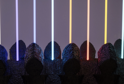 Abstract art with textured black shapes in the foreground, featuring vertical neon light bars in blue, purple, orange, and red against a gradient background.