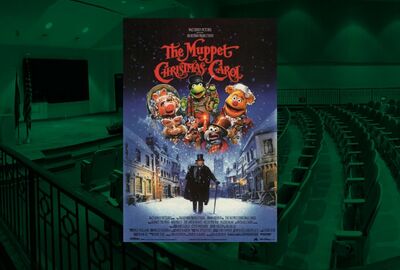 Poster for "The Muppet Christmas Carol" featuring Muppets in festive outfits over a snowy Victorian street. Dark green theater with seats, stage and big screen television in the background of the design.