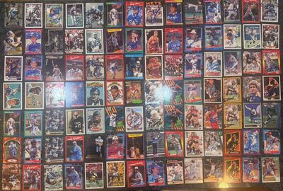 A colorful assortment of vintage sports trading cards featuring various athletes engaged in action poses. Cards are neatly arranged, showcasing diverse sports.