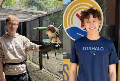 A young man smiles while holding a hawk, and another young man poses in a dark blue shirt.